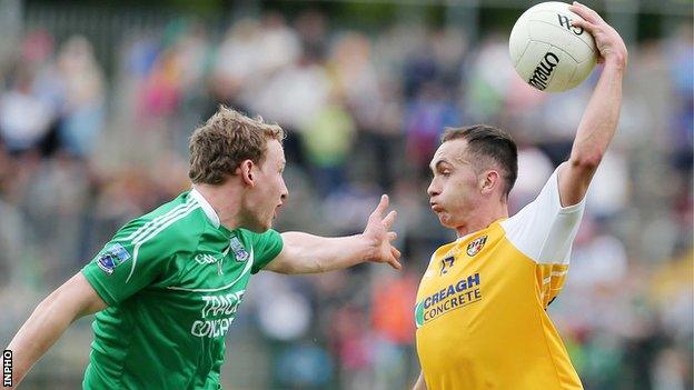 Fermanagh's Aiden Breen attempts to close down Antrim forward Brian Neeson