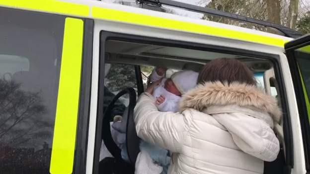 Baby being lifted into ambulance