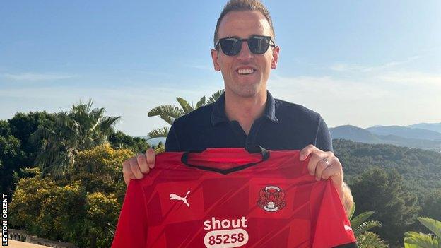 Harry Kane poses with a Leyton Orient shirt