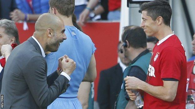 Bayern Munich boss Pep Guardiola (left) celebrates with Robert Lewandowski after the final whistle