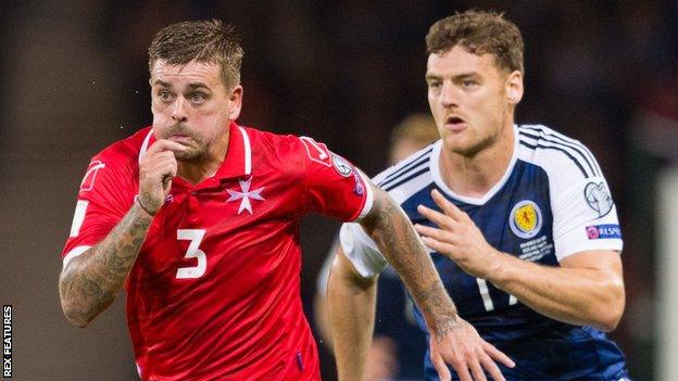 Malta's Samuel Magri is chased by Scotland's Chris Martin