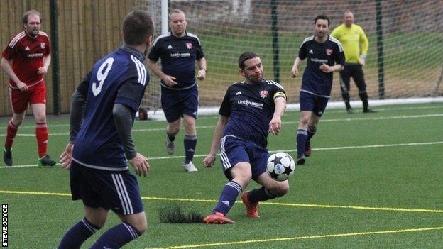 Rob McPherson playing for the Village Manchester football team