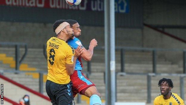 Timothee Dieng's late confrontation with Jordan Clarke earned a penalty and a red card for the Scunthorpe captain