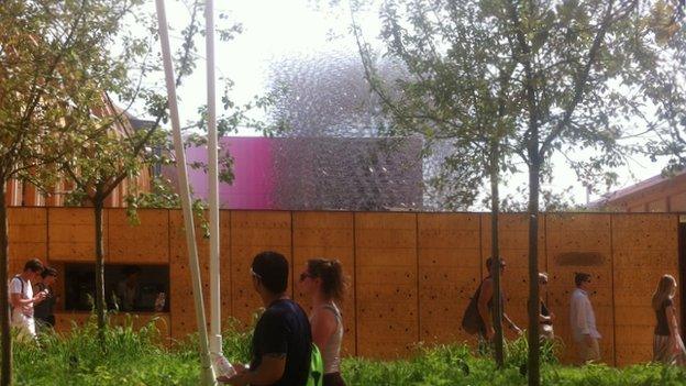 People walk past Wolfgang Buttress' Hive