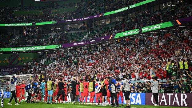 The South Korea players enjoyed their achievement with their fans long after their own match had ended