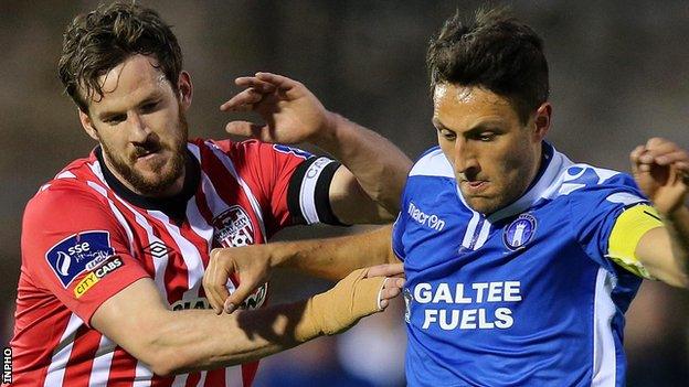 Derry skipper Ryan McBride challenges Shane Duggan of Limerick