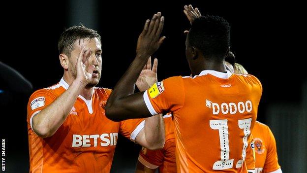 Steve Davies and Joe Dodoo celebrate a goal for Blackpool