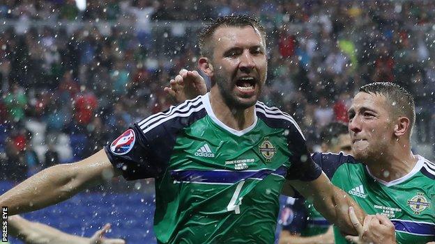 Gareth McAuley celebrates after scoring his eighth international goal