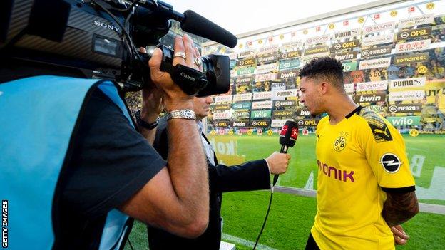 Jadon Sancho is interviewed on the pitch after a game