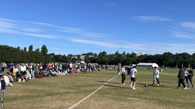 Members of the queue play football as they wait for Wimbledon