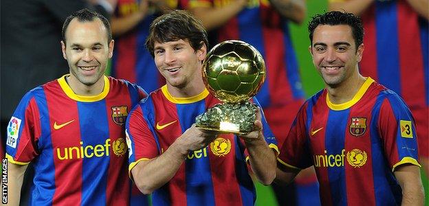 Barcelona's midfielder Andres Iniesta (left) with team-mates Lionel Messi and Xavi