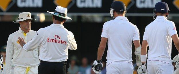 Michael Clarke of Australia (left) speaks to Umpire Aleem Dar as James Anderson of England looks on