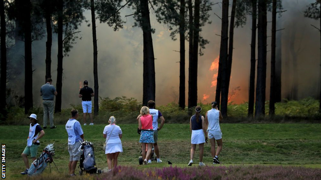 Players watch the fire at Wentworth