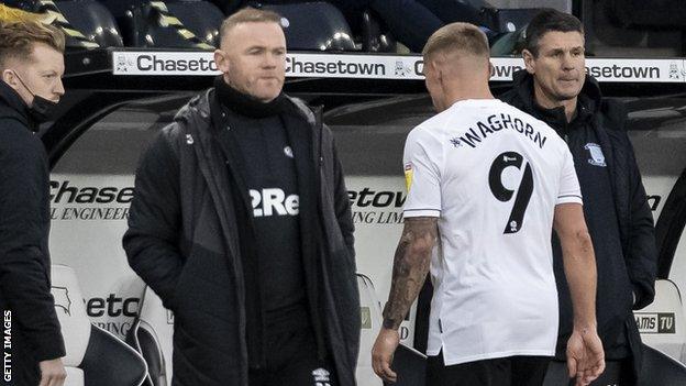 Wayne Rooney looks at Martyn Waghorn as he trudges off following a red card