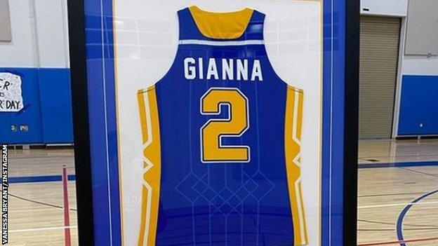 Gianna Bryant's jersey is being displayed on the wall in the school gym