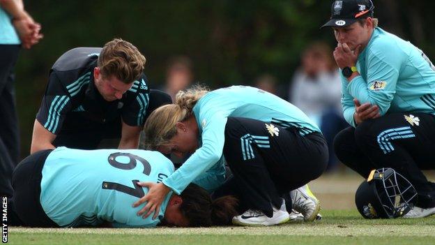 Grace Gibbs is comforted by Surrey Stars team-mates after being injured at Guildford