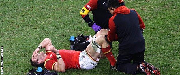 Dan Lydiate receiving treatment after injuring a knee playing for Wales against South Africa