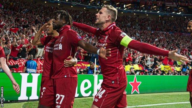 Origi celebrates with Fabinho and Jordan Henderson after scoring in the 2019 Champions League final.