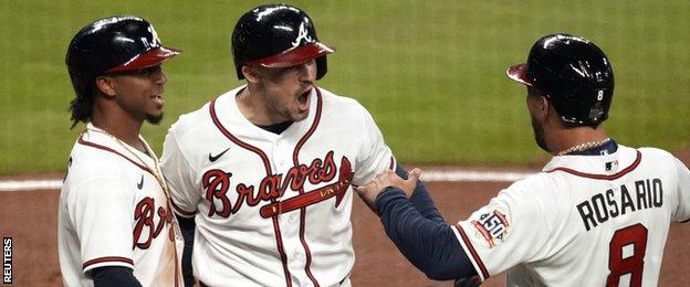 Adam Duvall (centre) celebrates his first-inning grand slam for the Atlanta Braves