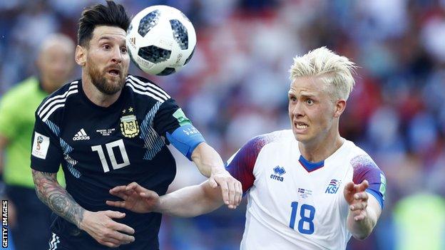 Hordur Magnusson tussles with Lionel Messi