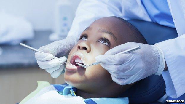 Child have his teeth examined by dentist