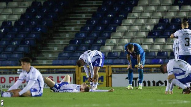 Inverness CT and Queen of the South players show their exhaustion