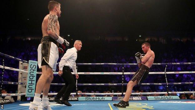 Scott Cardle falls to the floor as he is knocked down by Ricky Burns