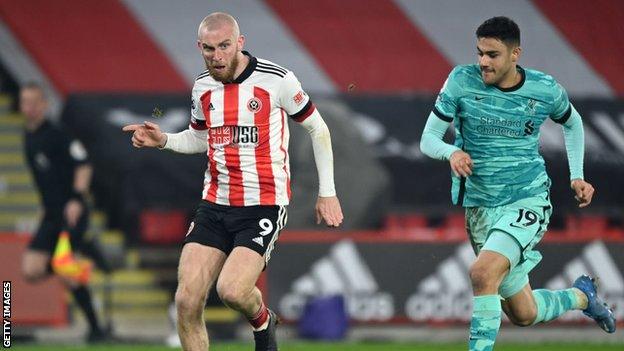 Oli McBurnie holds off Liverpool's Ozan Kabak at Bramall Lane