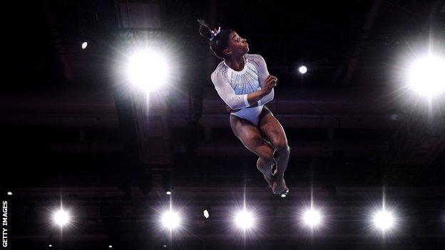 Simone Biles competes on the floor during the women's all-around final in Stuttgart