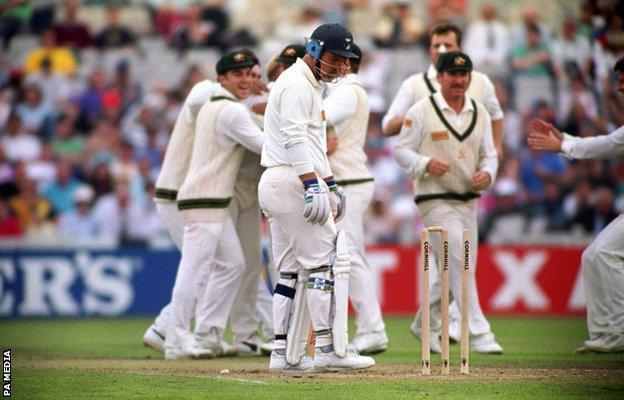 England's Mike Gatting (centre) is bowled out by Shane Warne's first delivery of the day at Old Trafford.