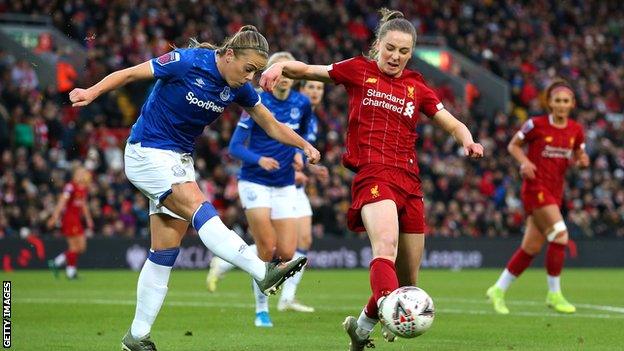 Everton's Simone Magill clears the ball from Liverpool's Niamh Charles in the WSL derby at Anfield in November 2019