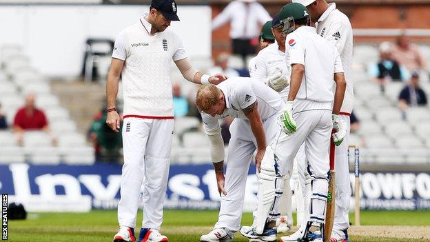 Ben Stokes clutches his right leg