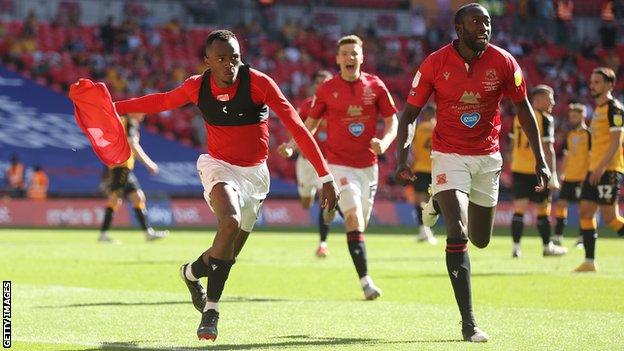 Carlos Mendes Gomes celebrates after scoring Morecambe's winner against Newport County