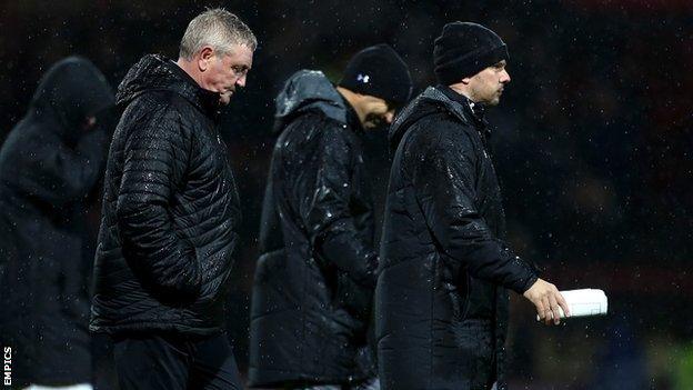 A wet night at Griffin Park turned into a miserable one for Steve Bruce and his backroom team Colin Calderwood and Stephen Clemence (right)