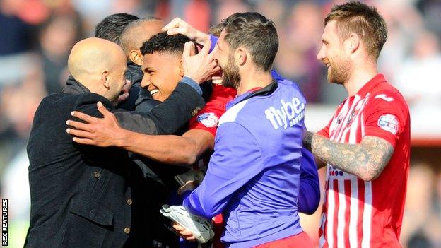 Paul Tisdale (left) led the congratulations for Watkins after his late goal secured victory over Plymouth Argyle