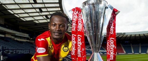 Partick Thistle midfielder Abdul Osman with the Premiership trophy