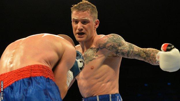 Croatian Ivan Njegac covers up as Ricky Burns lands another punch during his win at the Metro Radio Arena in Newcastle