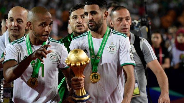 Yacine Brahimi (left) celebrates with Riyad Mahrez after winning the Africa Cup of Nations