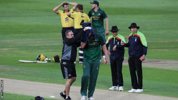 Luke Fletcher is helped from the pitch after being struck on the head by the ball