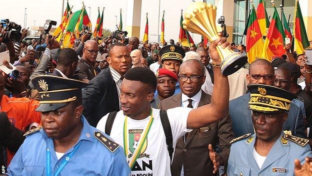 Cameroon's players were welcomed by fans at the airport on their return from Gabon on Monday