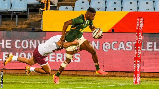 South Africa wing Aphelele Fassi runs over the tryline to score