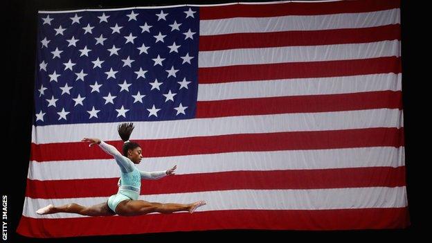 Simone Biles with the American flag