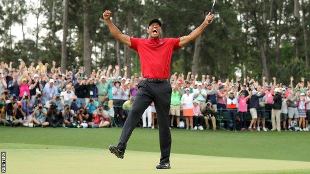 Tiger Woods celebrates on the 18th hole after winning the 2019 Masters