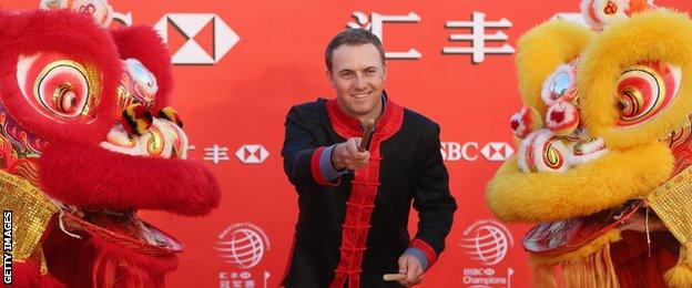 Jordan Spieth performs on stage with two Chinese dragons during a photocall for the Champions Tour in Shanghai