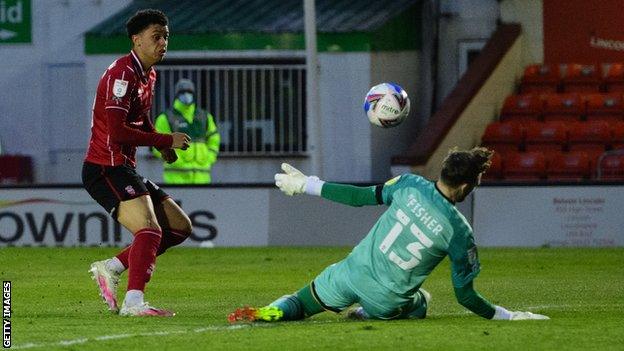 Brennan Johnson scores the first of his three goals against MK Dons