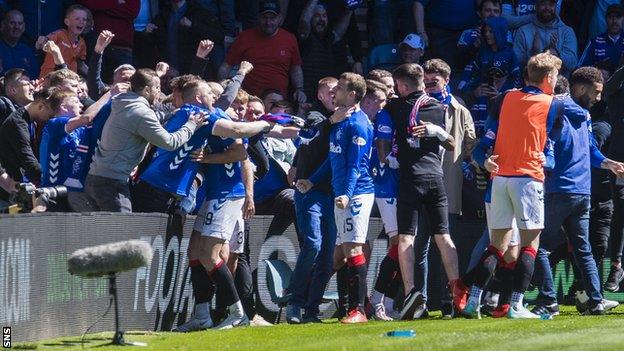 Rangers fans spill on to the park as their side score the second