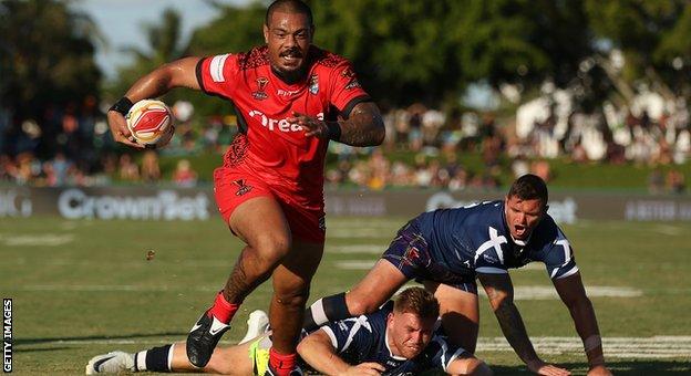 Sika Manu of Tonga makes a break to score a try