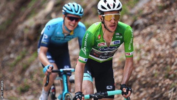 Britain's Simon Yates attacks while wearing the green leader's jersey at the 2021 Tour of the Alps