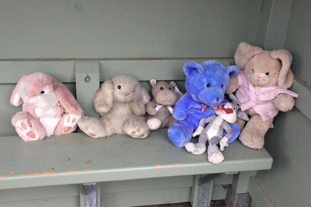 Cuddly toys at bus stop