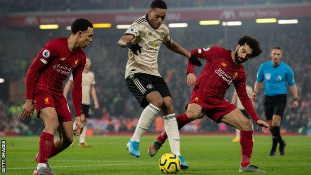 Manchester United's Anthony Martial holds off Liverpool's Mohamed Salah and Trent Alexander-Arnold